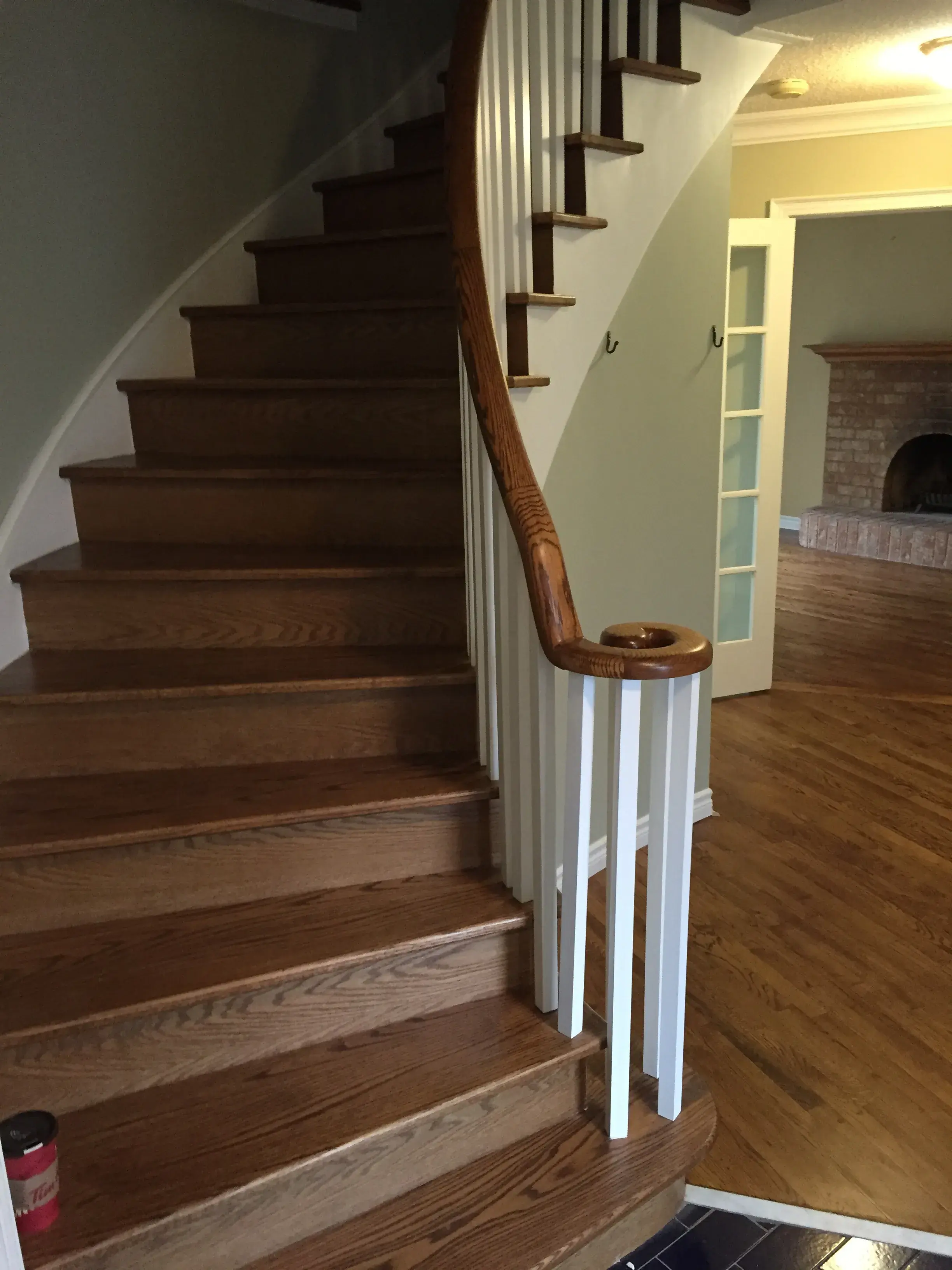 Entry staircase with stained oak treads and matching handrail