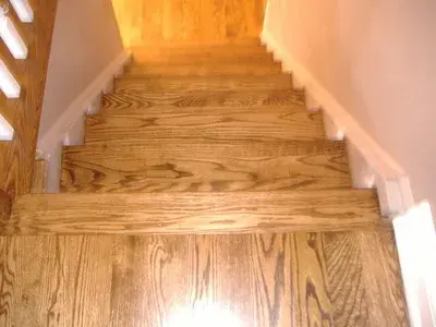 Refinished wooden staircase with hand-stained treads
